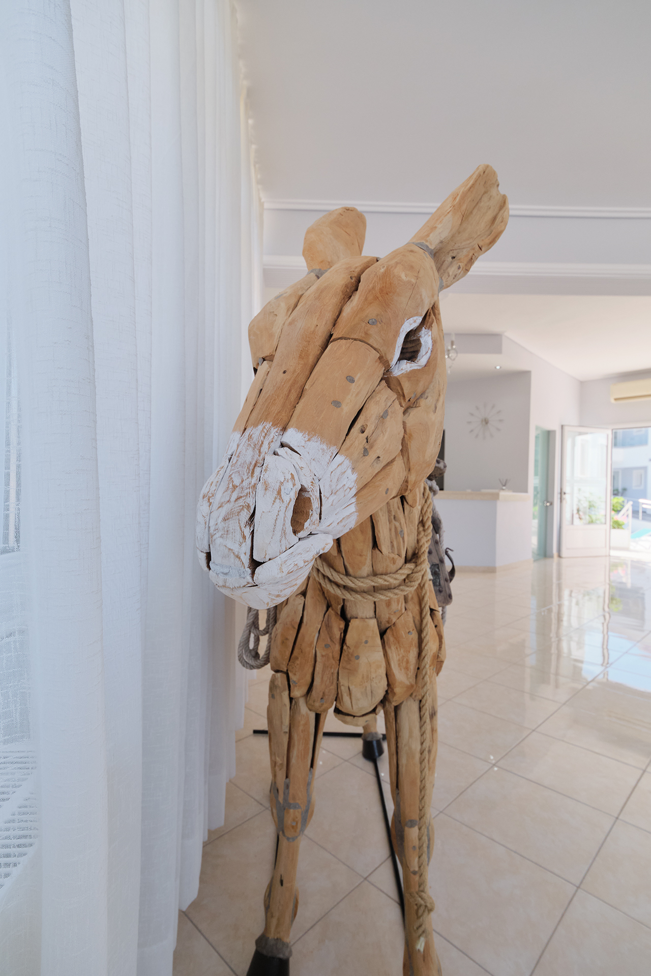 Wooden donkey sculpture at Hotel Defkalion